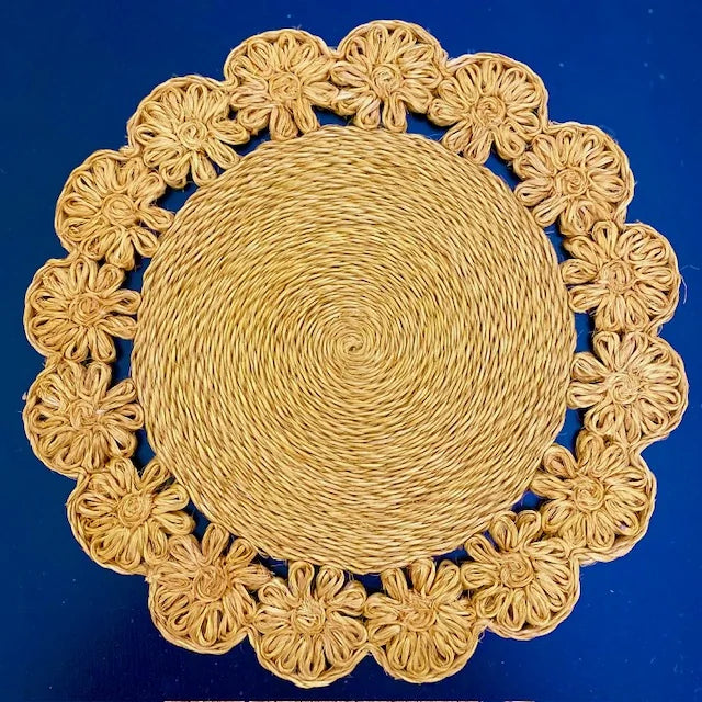 Close-up of a Daisy Braided Abaca placemat in a natural tan color, featuring hand-braided floral petals and soft organic texture for a boho-chic tablescape.