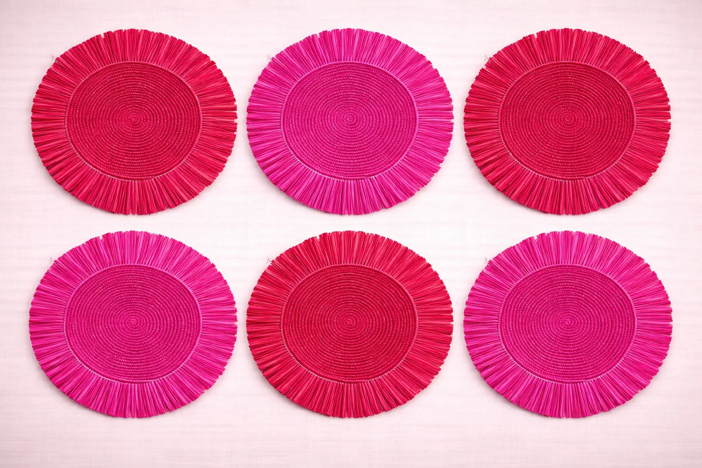 Rose Garden table setting featuring a blush-toned red and pink handwoven fringe placemats.