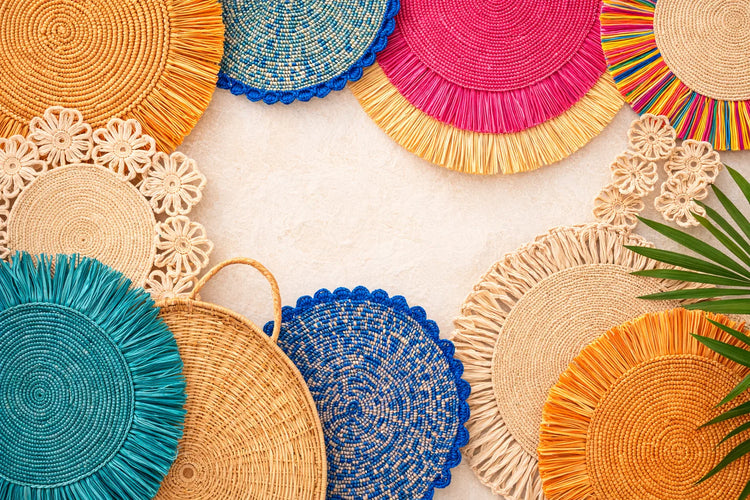 A diverse collection of colorful and textured handwoven charger plates in various bohemian and rustic styles.