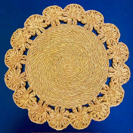 Close-up of a Daisy Braided Abaca placemat in a natural tan color, featuring hand-braided floral petals and soft organic texture for a boho-chic tablescape.