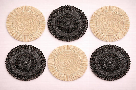Natural Contrast table setting featuring black and white beige handwoven raffia and abaca charger plates with minimalist boho accessories.