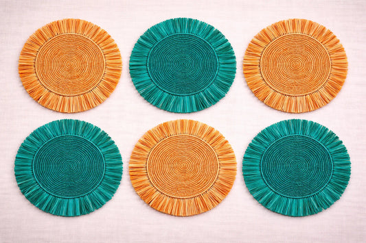 Citrus Grove table setting featuring a yellow or orange handwoven charger plate in orange and green.