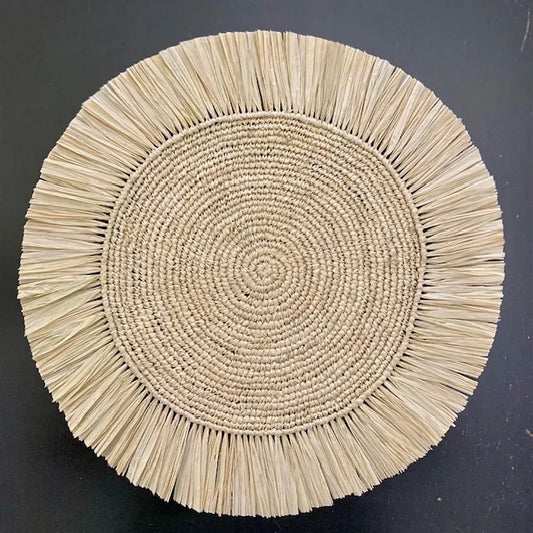 Top-down view of a Soleil Fringe vanilla cream raffia placemat, showing the radiant off-white fringe border and soft handwoven texture for a coastal-chic table.