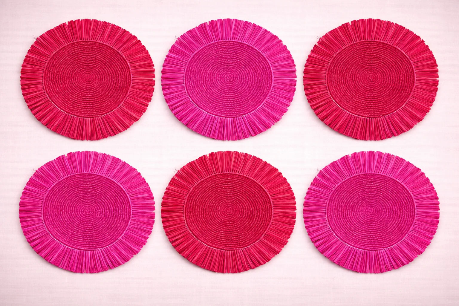 Rose Garden table setting featuring a blush-toned red and pink handwoven fringe placemats.