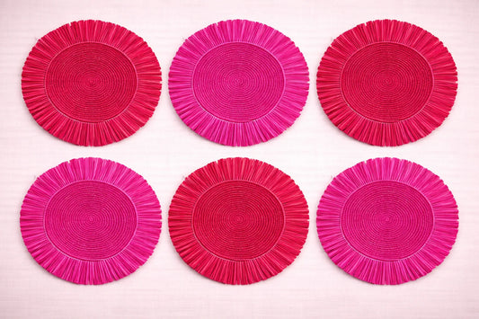 Rose Garden table setting featuring a blush-toned red and pink handwoven fringe placemats.