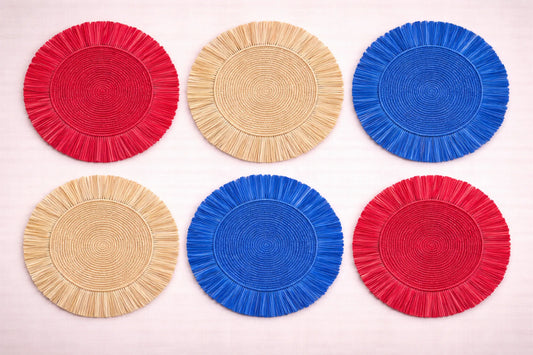 Stars and Stripes patriotic table setting with a handwoven charger plate and red, white, and blue decorations.